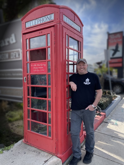 Rogue Standing next to a phone booth